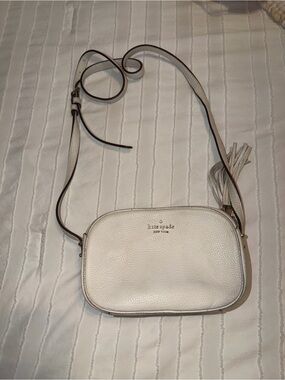 kate spade cream pebbled leather crossbody with tassel